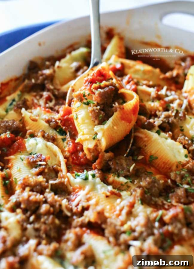 Baked Stuffed Shells 7 Stuffed shells with meat and marinara sauce on a plate.