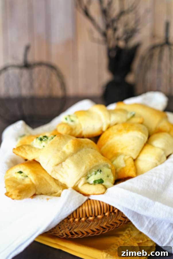 Spinach & Feta Puffs 3 Another view of Cheesy Spinach Crescents on a baking sheet.