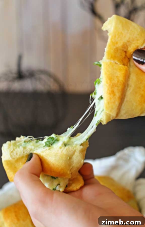 Spinach & Feta Puffs 4 Close-up of warm, cheesy spinach crescents, showing melted cheese.
