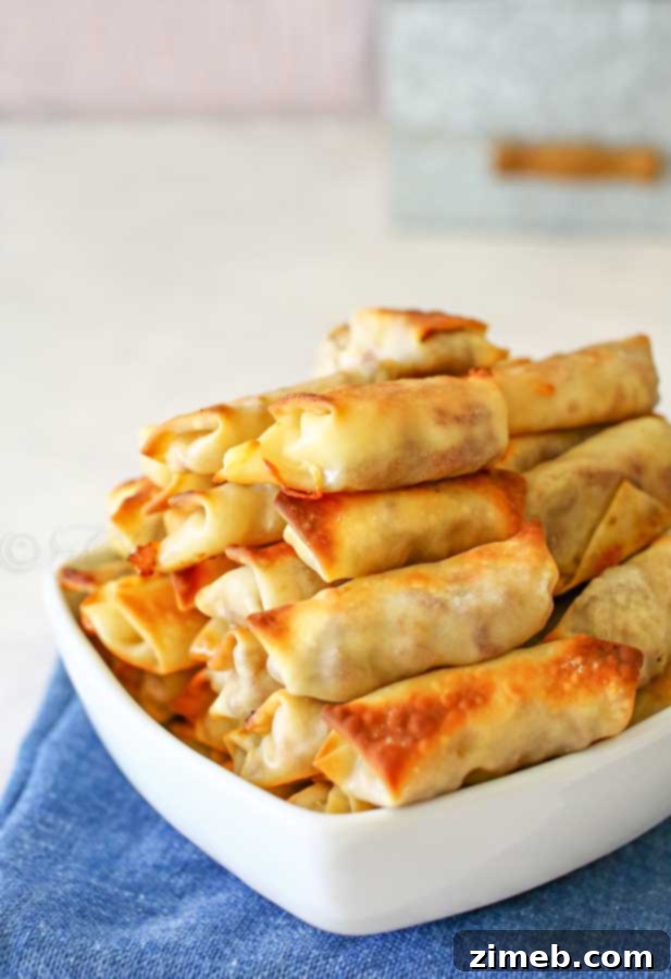 Close-up of baked Cheesy Roast Beef Egg Roll Bites showing melted cheese