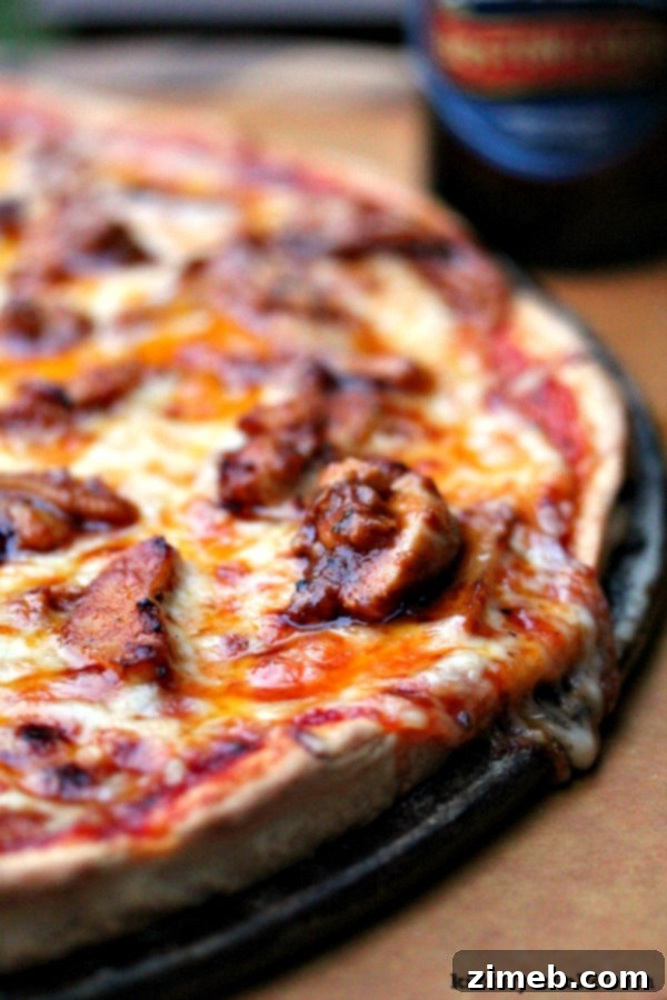 A perfectly baked Buffalo Chicken Pizza, topped with shredded chicken, cheese, and a drizzle of spicy buffalo sauce.