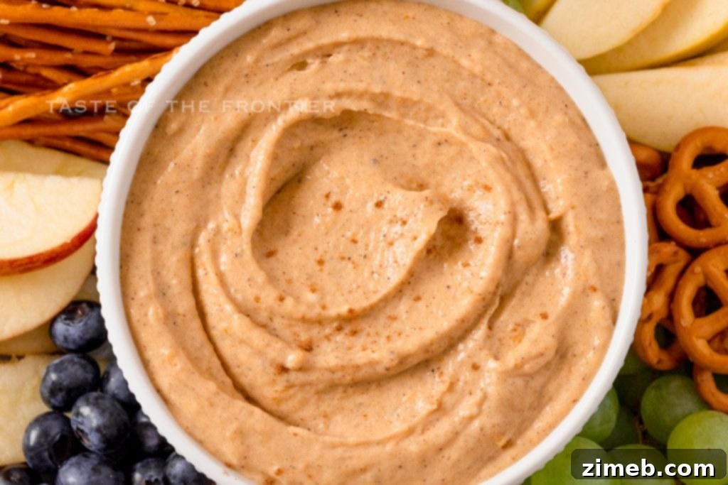 Pumpkin Pie Dip 7 A creamy, no-bake pumpkin dessert dip served in a bowl with various dippers.