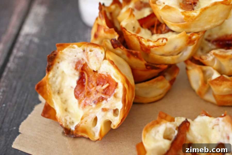 Creamy Bacon Alfredo Cheese Cups 3 Close-up of crispy Bacon Alfredo Cheese Cups in a muffin tin, freshly baked and golden brown.