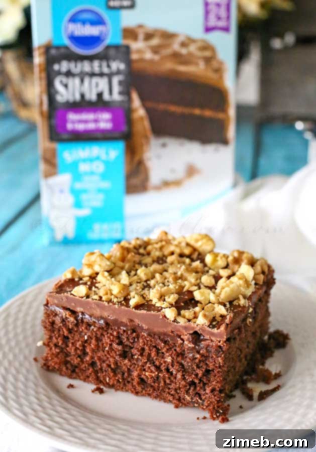 Decadent Walnut and Toffee Chocolate Poke Cake 6 Walnut and toffee bits being sprinkled generously over the frosted chocolate poke cake