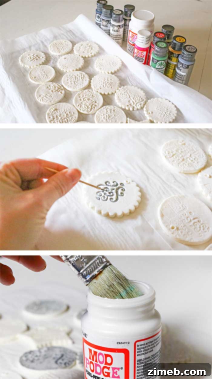 Close-up of a hand carefully painting intricate details on a baked Stamped Clay Ornament, highlighting the post-baking decoration process.