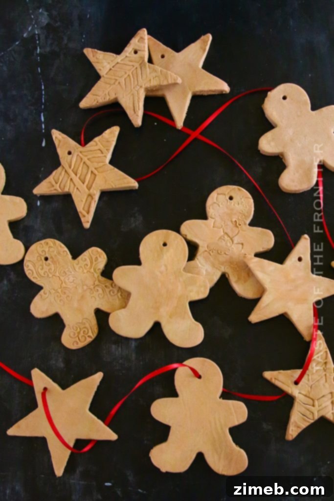 A collection of white, unpainted homemade clay ornaments with various stamped designs, ready for customization.