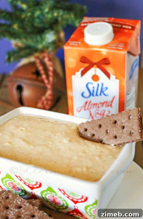 Creamy Dairy-Free Eggnog Dip 3 Dairy Free Eggnog Dip served elegantly with festive dippers on a wooden board