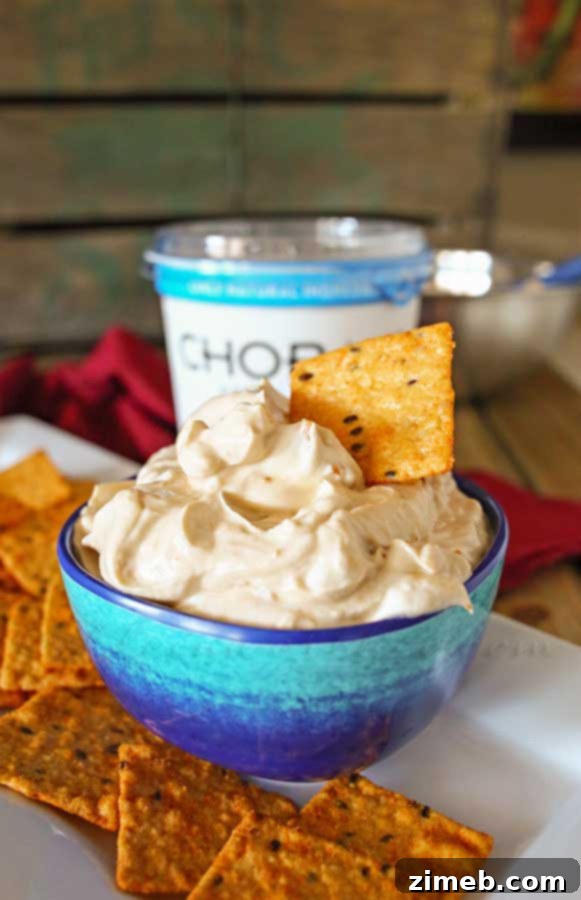 Effortless Homemade French Onion Dip 5 Mixing Chobani Greek yogurt with French onion seasoning in a bowl to create a smooth, creamy dip.