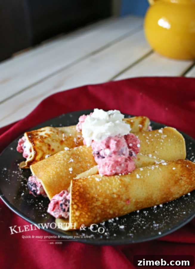 Swedish Crêpes 4 Stack of Swedish Pancakes with a drizzle of syrup and berries.