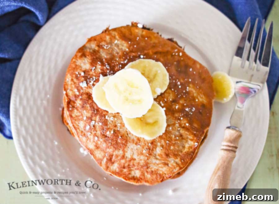 Quick and Easy 3 Ingredient Chocolate Protein Pancakes 3 Close-up of fluffy 3-Ingredient Chocolate Protein Pancakes with banana slices
