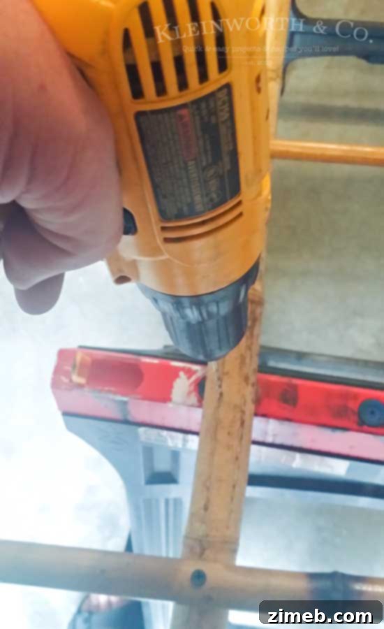 Marking pilot holes on bamboo for blanket ladder