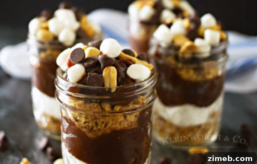 Close-up view of a beautifully layered Rocky Road Pudding Jar, highlighting the textures of chocolate, graham crackers, marshmallows, and nuts