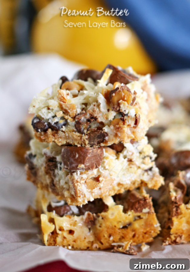 Rich Peanut Butter Seven Layer Bars, featuring layers of chocolate, nuts, and peanut butter goodness, cut into squares