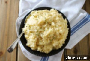 Close-up of creamy risotto served in a Crock-Pot, showing a rich, smooth texture with a slightly golden hue, indicating perfectly cooked grains.