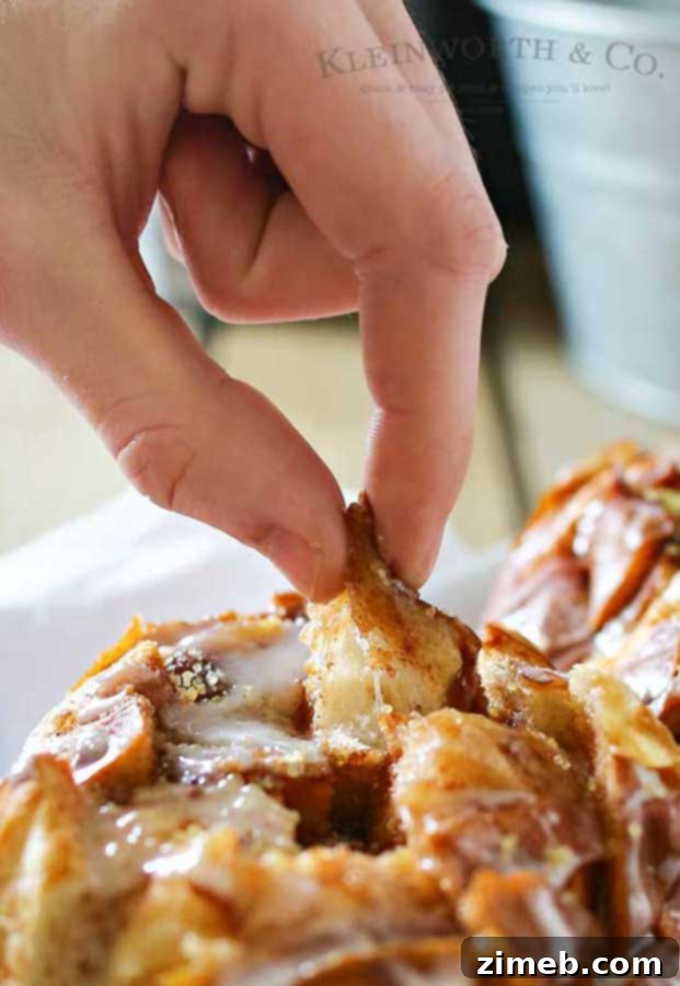 Gooey Cinnamon Pull-Apart Loaf 5 Cinnamon Roll Pull Apart Bread drizzled with glaze, fresh from the oven.