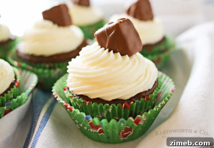 Score Big Snickers Cupcakes 3 Easy Game Day Snickers Cupcakes with a simple soda cake base, infused with chopped Snickers, and frosted beautifully.