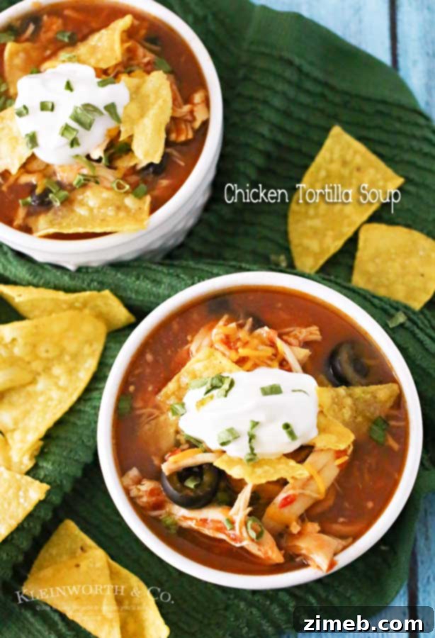 A beautifully presented bowl of Slow Cooker Chicken Tortilla Soup, garnished with vibrant toppings like avocado, cheese, and cilantro, ready to be enjoyed.