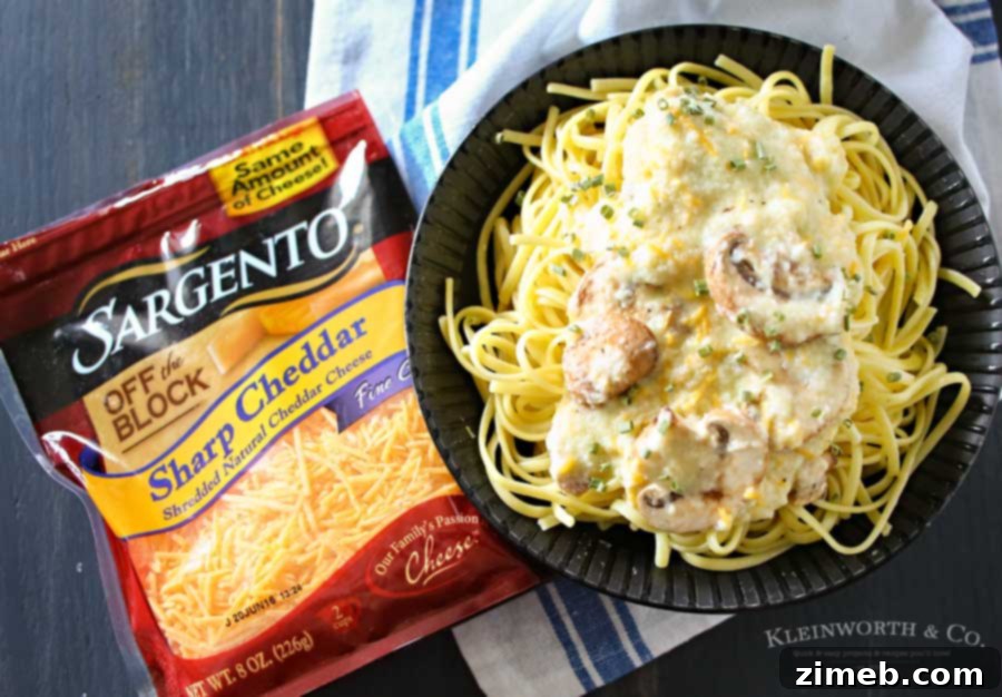 Mixing buttery garlic mushrooms and Sargento cheddar cheese into creamy sauce for linguine.