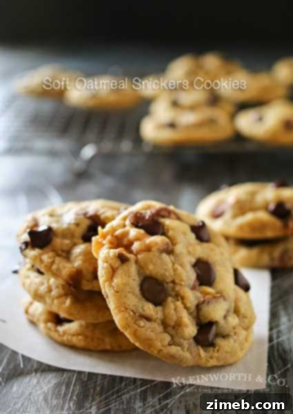 Soft Oatmeal Snickers Cookies, a thick & chewy oatmeal cookie stuffed with Snickers candy bars & chocolate chips, an easy and yummy treat.