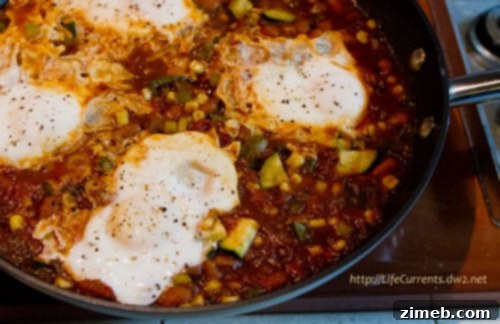 25 Delicious Egg Recipes 17 Easy Weeknight Skillet Eggs, bubbling with flavor in a cast-iron skillet.