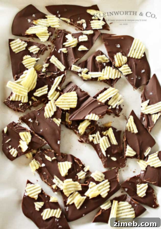 Potato Chip Bark and 40 Plus Potato Delights 4 Hand breaking a piece of Potato Chip Bark, highlighting the crispy texture