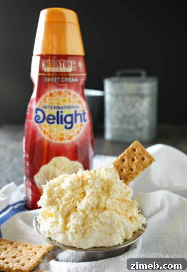 A festive display of Cinnamon Cheesecake Dip with various dippers and garnishes, suggesting a perfect party dessert setup.