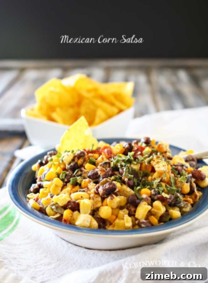 Street Corn Salsa 5 A bowl of fresh Mexican Corn Salsa, perfectly garnished, on a rustic background, highlighting its appeal as a party food.