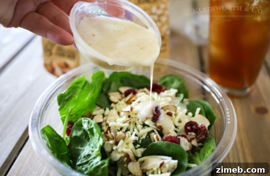 Sip and Savor: Vanilla Coconut Black Tea and Elevate Organic Salads 5 Variety of pre-packaged organic salads displayed in a grocery store, perfect for a quick and healthy lunch pairing.