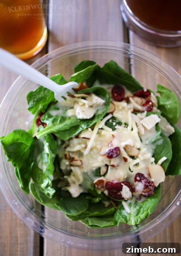 Sip and Savor: Vanilla Coconut Black Tea and Elevate Organic Salads 6 An open organic salad container, showing fresh greens, grains, and other nutritious ingredients, ready to eat.
