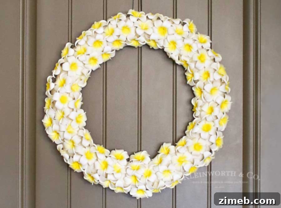 Tropical Plumeria Wreath 2 Lush Plumeria Wreath crafted from foam flowers, a perfect summer accent for any home's entryway.