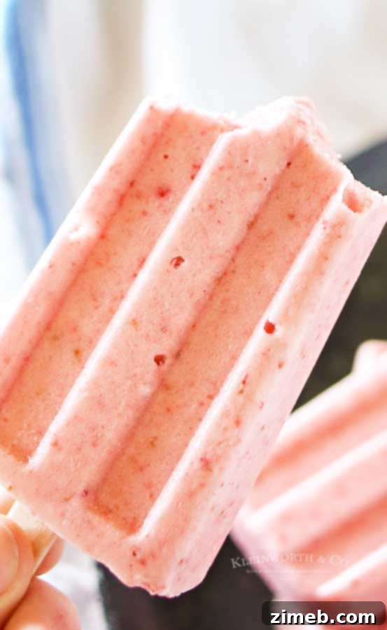 Delicious Dairy-Free Strawberry Coconut Pops on a rustic background.