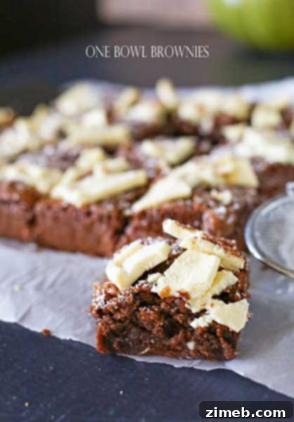 A plate of rich, fudgy One Bowl Brownies, topped with a dusting of powdered sugar.