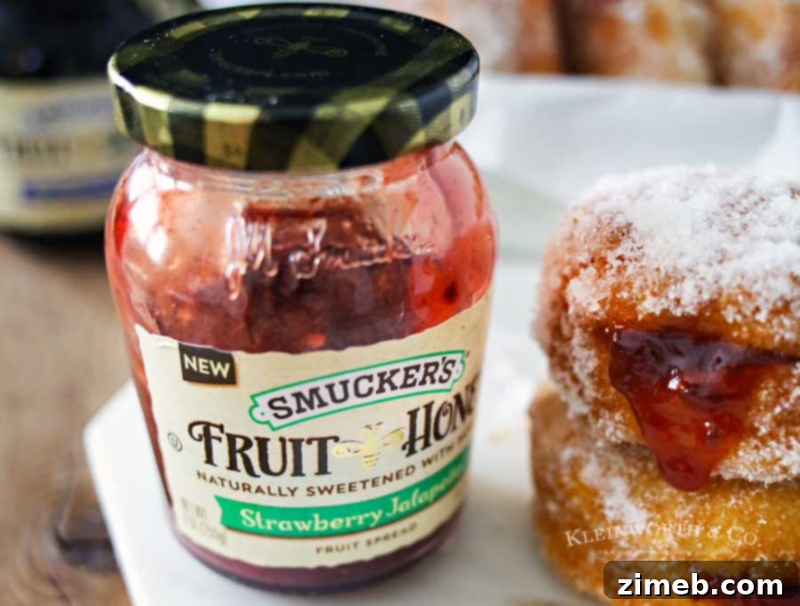 Homemade Strawberry Jalapeño Donuts being filled with a flavorful spread, showcasing a perfect breakfast idea