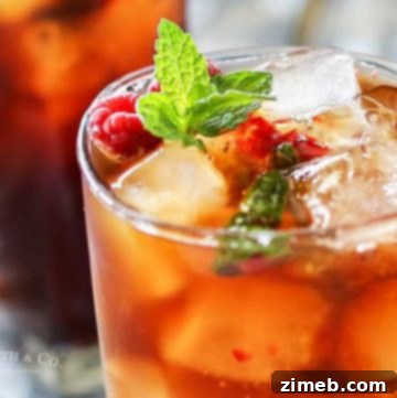 Spirited Raspberry Mint Iced Tea 5 A square image of Raspberry Mint Hard Iced Tea, ideal for a recipe card thumbnail, showing the drink's fresh ingredients.