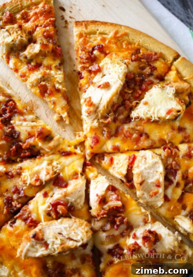 Spirited Raspberry Mint Iced Tea 8 Delicious Grilled Chicken & Bacon Pizza with Garlic Cream Sauce, shown fresh out of the oven, ideal for a hearty summer meal.