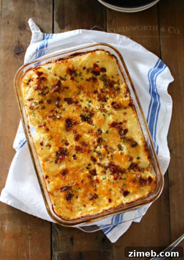 Creamy Bacon Scalloped Potatoes 3 Layered Scalloped Potatoes with Bacon and Cheese before baking, showcasing thin potato slices and rich ingredients.