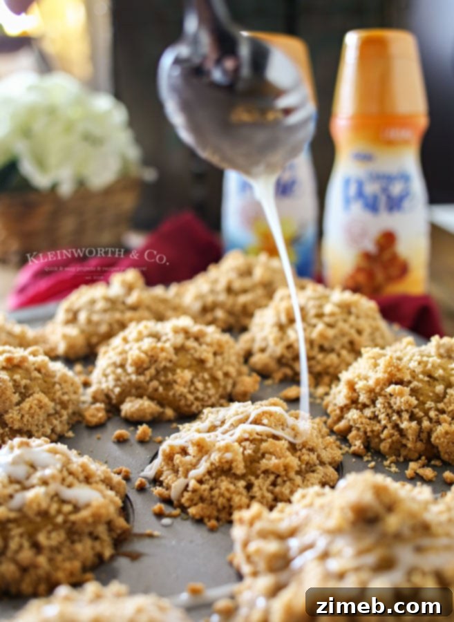 Pillowy soft Pumpkin Streusel Muffins with a rich caramel glaze