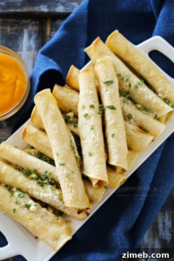 Crispy Pulled Pork Roll-Ups 4 Batch of Baked Pulled Pork Taquitos on a baking sheet, ready for serving