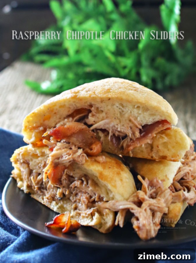 Closeup of Raspberry Chipotle Chicken Sliders, showcasing the shredded chicken, melted Brie, and colorful sauce.