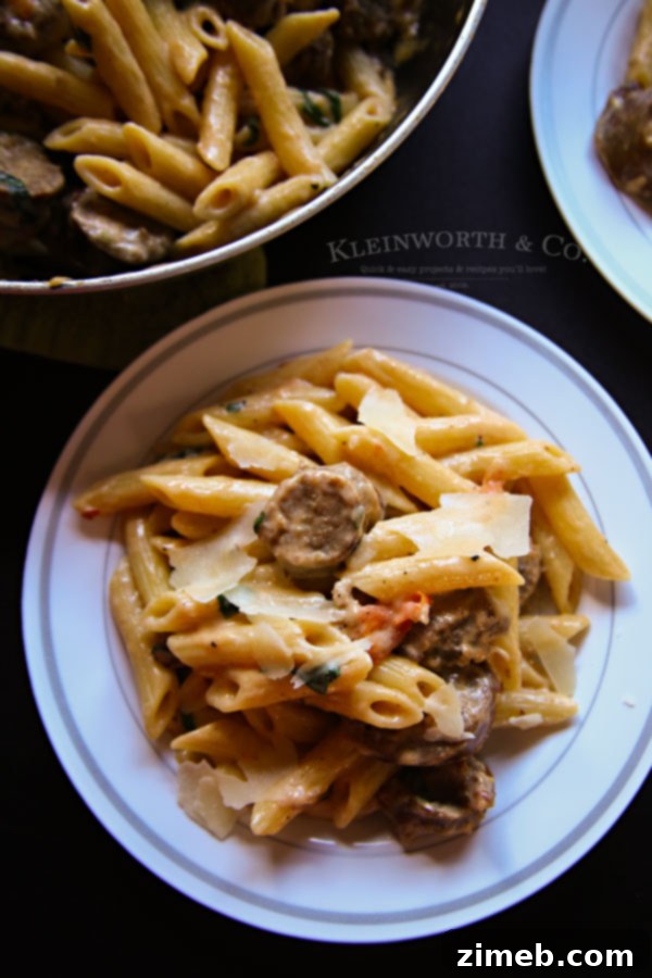 Classic Sausage Penne Alfredo 5 Penne Sausage Alfredo garnished with Parmesan cheese, ready to serve.