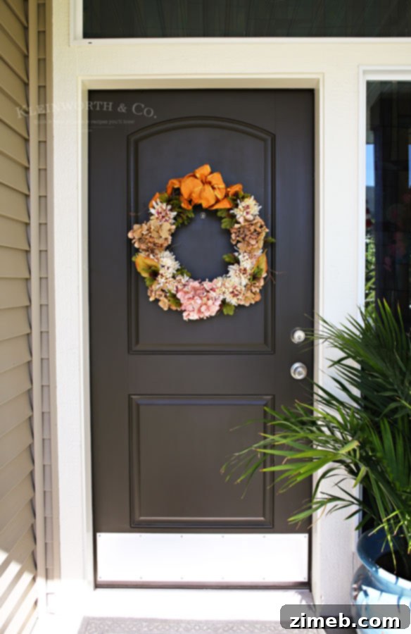 Grateful Harvest Wreath 6 Adding filler flowers and leaves to the Fall Thanksgiving Wreath