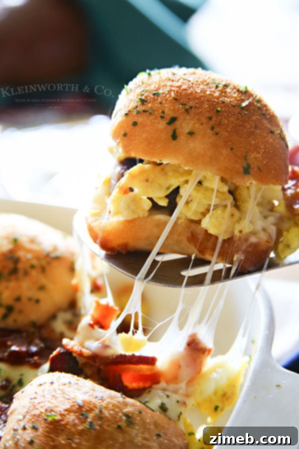 Ultimate Breakfast Sliders 6 Close-up of golden brown Sausage Egg Bacon Cheese Breakfast Sliders fresh from the oven.