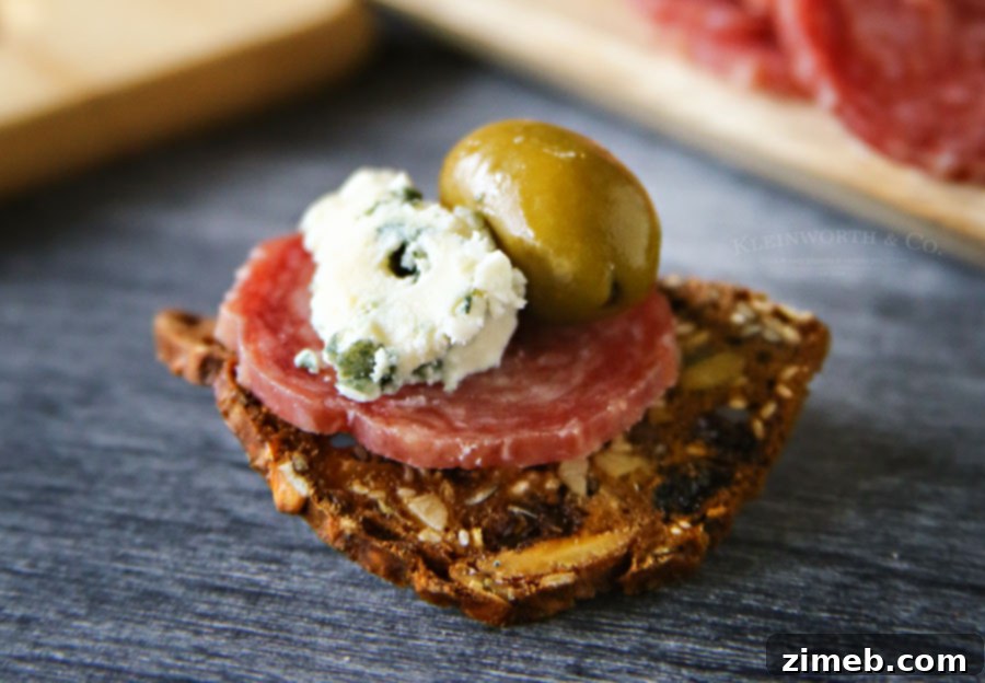 Blue Cheese Salami Appetizer on a rustic wooden board with wine