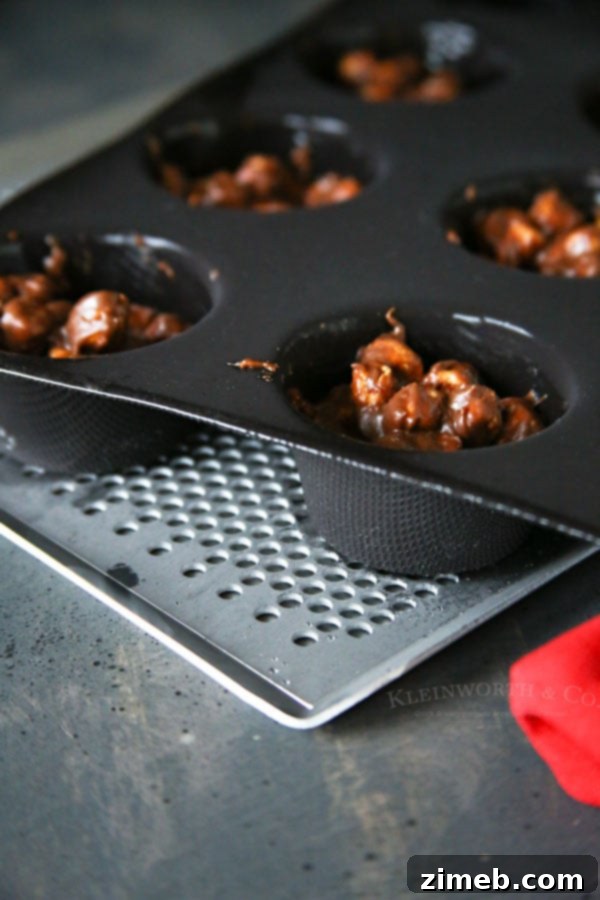 Rocky Road Express Bites 4 Rocky Road Clusters setting in a Demarle at Home Flexipan Muffin Tray