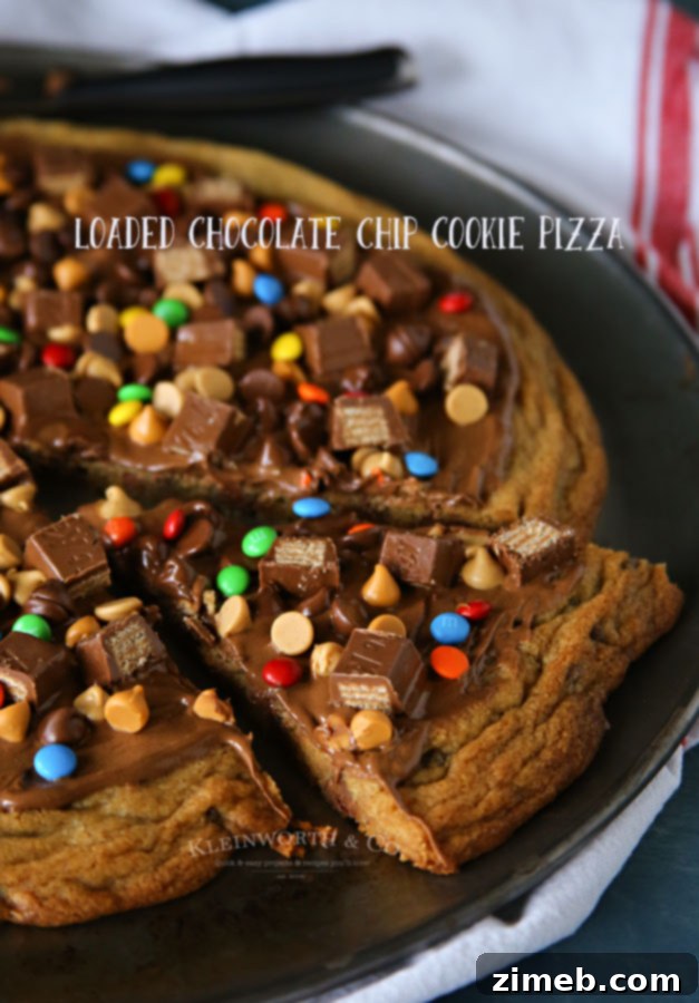 Ultimate Chocolate Chip Cookie Pizza 6 A large slice of Loaded Chocolate Chip Cookie Pizza, showcasing the irresistible layers of cookie and abundant toppings, ready for a dessert party or family gathering.