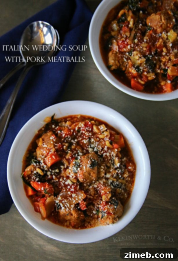 A person enjoying a bowl of Italian Wedding Soup with Pork Meatballs on a cozy evening.