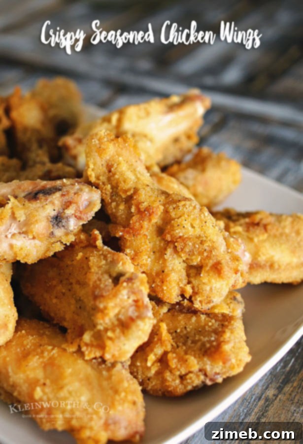 Golden Crisp Flavor Wings 5 Crispy Seasoned Chicken Wings served in a white bowl, garnished with fresh chives, ready to be enjoyed.