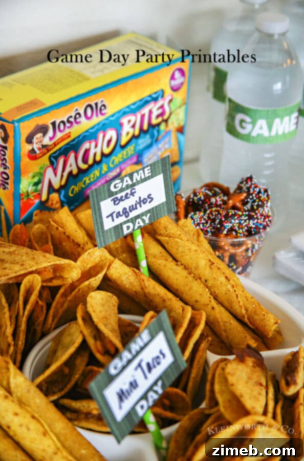 Game day party table with snacks and custom straw flags, bottle wrappers, and a banner