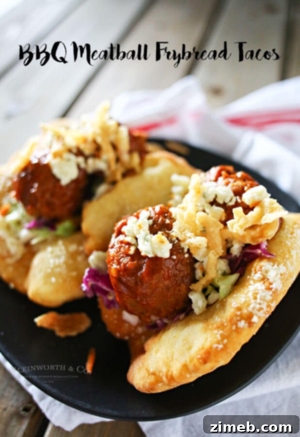Signature BBQ Meatball Fry Bread Tacos 5 A prepared BBQ Meatball Fry Bread Taco, ready to be enjoyed, with a focus on the delicious filling.