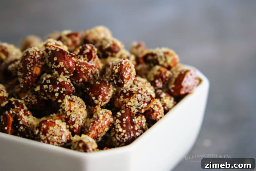 Close-up of golden honey roasted almonds scattered on a surface.